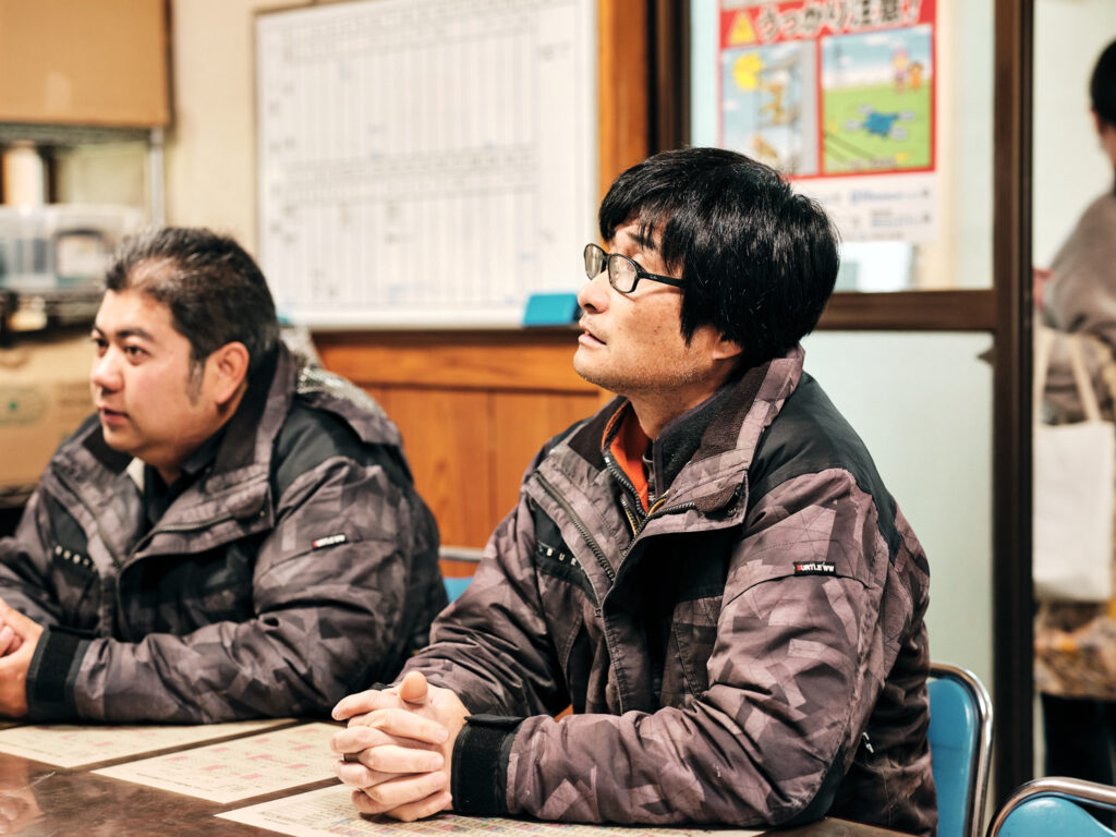 事務所で工事の打ち合わせを行うスタッフ